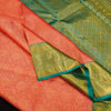 close view of premium bridal kanchipuram silk saree in peach orange colour with korvai border