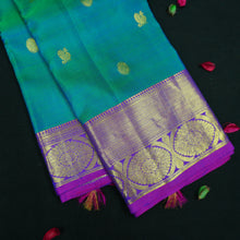 Load image into Gallery viewer, Peacock blue Kanchipuram silk saree with violet border, gold zari peacock and chakaram butta, and rich woven pallu – traditional bridal saree by Vivaaha Silks.