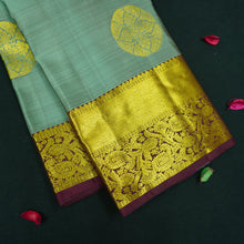 Load image into Gallery viewer, Grey Kanchipuram silk saree with gold zari chakaram butta, rich orange-gold pallu, and brown floral border – traditional wedding silk saree from Vivaaha Silks.