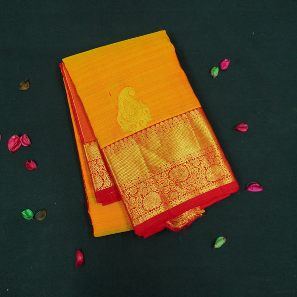 Mango yellow Kanchipuram silk saree with gold zari mango butta motifs, traditional red border, and rich pallu – bridal silk saree by Vivaaha Silks.