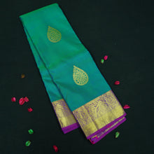 Load image into Gallery viewer, Peacock blue Kanchipuram silk saree with gold zari thilagam butta motifs, violet border, and rich woven pallu – traditional bridal silk saree by Vivaaha Silks.