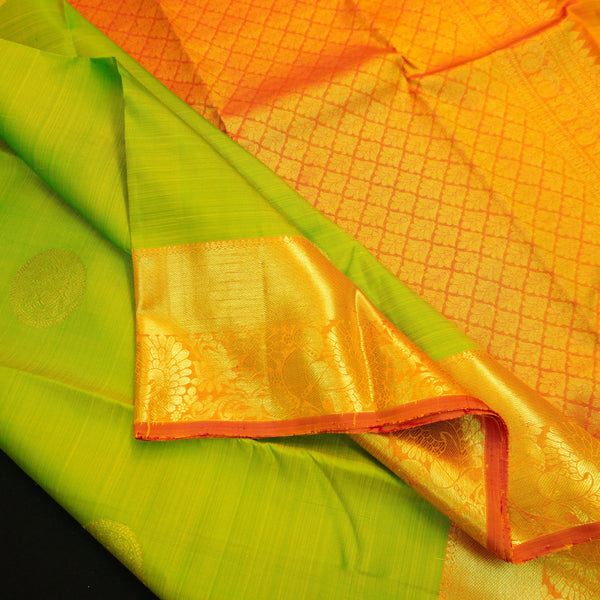 Parrot green Kanchipuram silk saree with pink orange zari border and gold buttas, traditional pattu saree for wedding wear.