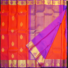 Load image into Gallery viewer, Tomato red Kanchipuram silk saree with violet zari border and pallu, featuring gold thilagam motifs.