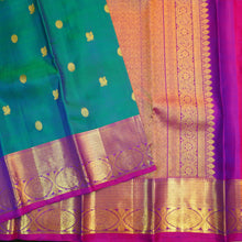 Load image into Gallery viewer, Peacock blue Kanchipuram silk saree with violet border, gold zari peacock and chakaram butta, and rich woven pallu – traditional bridal saree by Vivaaha Silks.