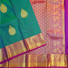 Load image into Gallery viewer, Peacock blue Kanchipuram silk saree with gold zari thilagam butta motifs, violet border, and rich woven pallu – traditional bridal silk saree by Vivaaha Silks.