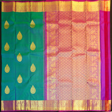Load image into Gallery viewer, Peacock blue Kanchipuram silk saree with gold zari thilagam butta motifs, violet border, and rich woven pallu – traditional bridal silk saree by Vivaaha Silks.