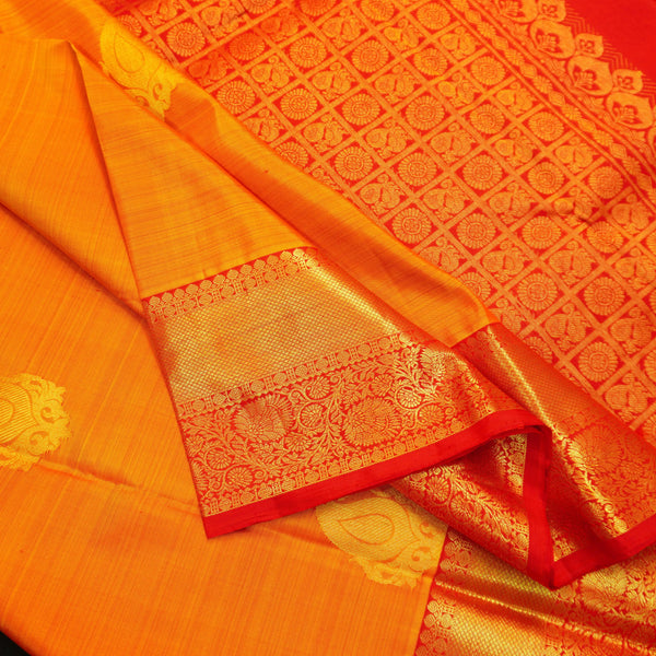 Mango yellow Kanchipuram silk saree with gold zari mango butta motifs, traditional red border, and rich pallu – bridal silk saree by Vivaaha Silks.