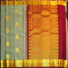 Load image into Gallery viewer, Grey Kanchipuram silk saree with gold zari chakaram butta, rich orange-gold pallu, and brown floral border – traditional wedding silk saree from Vivaaha Silks.