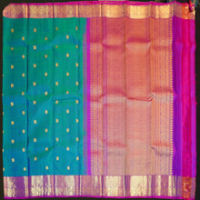 Load image into Gallery viewer, Peacock blue Kanchipuram silk saree with violet border, gold zari peacock and chakaram butta, and rich woven pallu – traditional bridal saree by Vivaaha Silks.