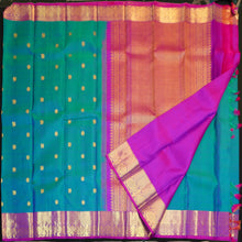Load image into Gallery viewer, Peacock blue Kanchipuram silk saree with violet border, gold zari peacock and chakaram butta, and rich woven pallu – traditional bridal saree by Vivaaha Silks.