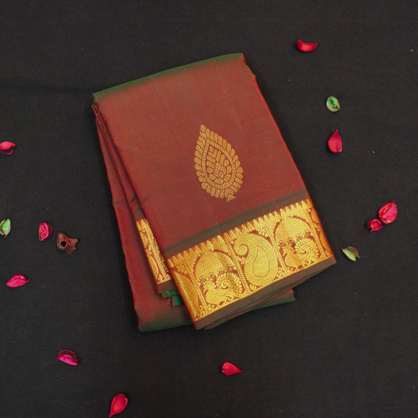 Manthulir short color Kanchipuram silk saree from Vivaaha Silks budget collection featuring golden thilagam buttas and rich zari pallu with traditional border.