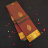 Manthulir short color Kanchipuram silk saree from Vivaaha Silks budget collection featuring golden thilagam buttas and rich zari pallu with traditional border.