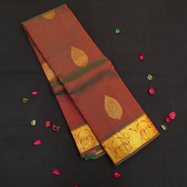 Manthulir short color Kanchipuram silk saree from Vivaaha Silks budget collection featuring golden thilagam buttas and rich zari pallu with traditional border.