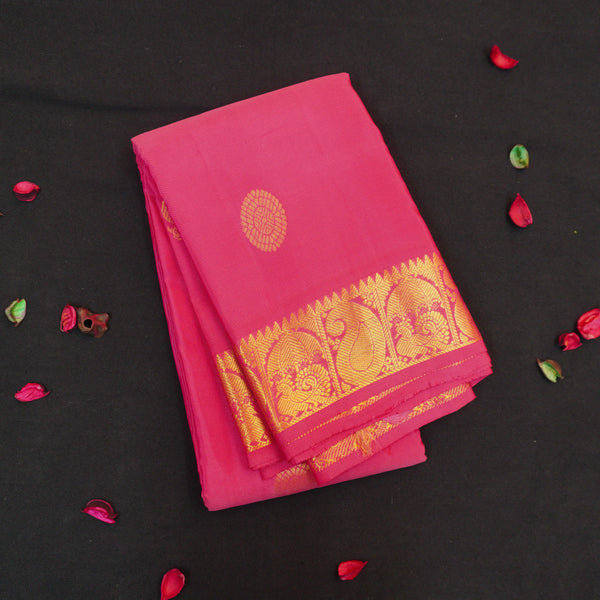 Peach pink Kanchipuram silk saree with gold annam and chakaram butta motifs, rich zari pallu, and traditional temple border – perfect for bridal and festive wear from Vivaaha Silks.