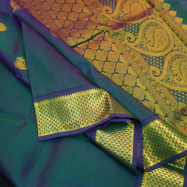 Peacock blue Kanchipuram silk saree from Vivaaha Silks budget collection featuring gold annam and chakaram butta, and a grand zari pallu with paisley and diamond motifs.