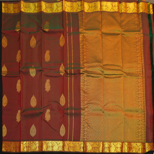 Manthulir short color Kanchipuram silk saree from Vivaaha Silks budget collection featuring golden thilagam buttas and rich zari pallu with traditional border.