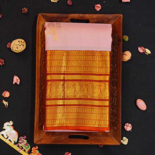 Baby pink Kanchipuram silk saree with gold annam butta motifs and orange-gold Korvai border