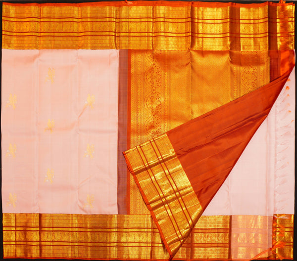Baby pink Kanchipuram silk saree with gold annam butta motifs and orange-gold Korvai border