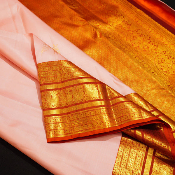 Baby pink Kanchipuram silk saree with gold annam butta motifs and orange-gold Korvai border