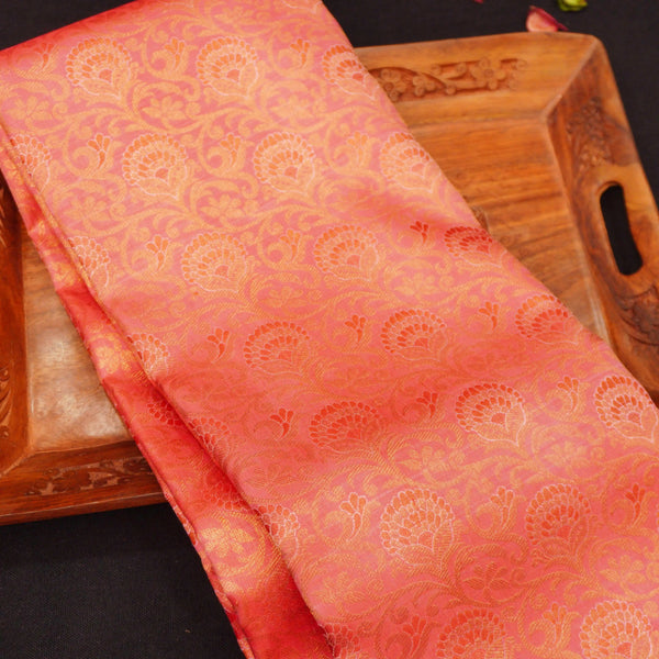  close view of premium bridal kanchipuram silk saree in peach orange colour with korvai border