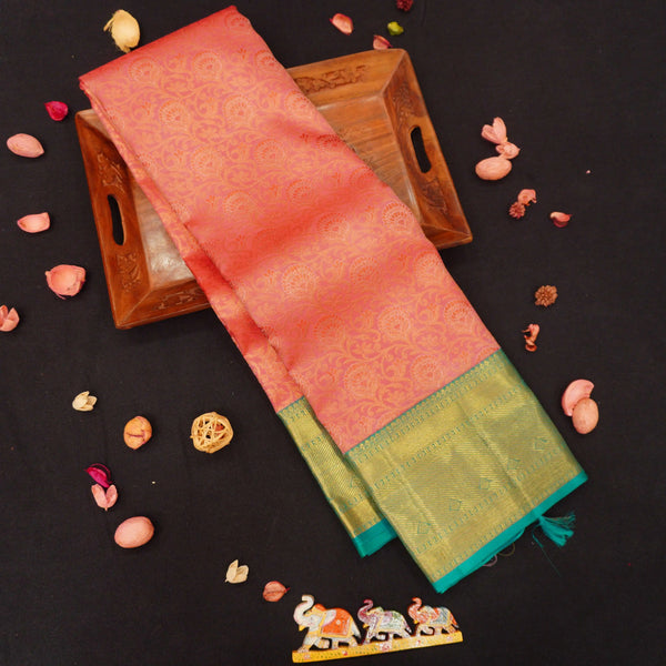  close view of premium bridal kanchipuram silk saree in peach orange colour with korvai border