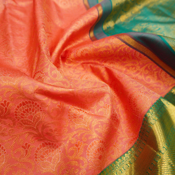  close view of premium bridal kanchipuram silk saree in peach orange colour with korvai border