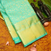 Close view of premium bridal kanchipuram silk saree in anandha colour with folral zari jaal
