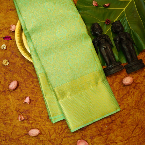 Close view of premium bridal kanchipuram silk saree in pastel green colour with geomentric floral design