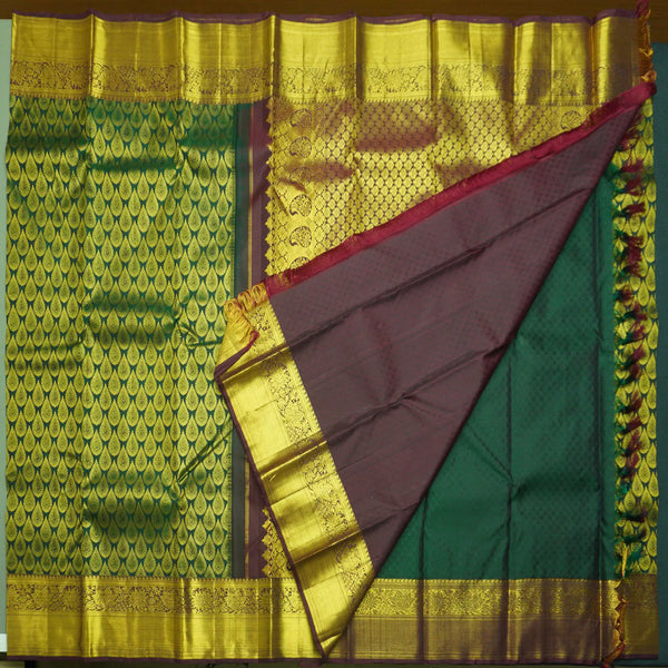 Traditional Dark Green Kanchipuram Silk Saree with Zari Thilagam Design
