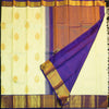 Lemon yellow vintage Kanchipuram silk saree with navy blue korvai border, featuring gold floral thilagam motifs on the body and a richly woven traditional zari pallu.