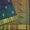 Peacock blue Kanchipuram silk saree from Vivaaha Silks budget collection featuring gold annam and chakaram butta, and a grand zari pallu with paisley and diamond motifs.