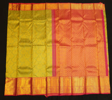 Load image into Gallery viewer, bridal kanjivaram silk saree in elaichi green with pink border handwoven with pure gold zari

